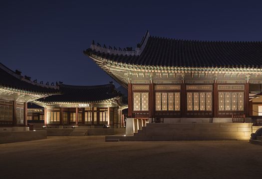 Gyeongbokgung Palace in Seoul illuminated by ERCO, enhancing its pagoda-style architecture at night.