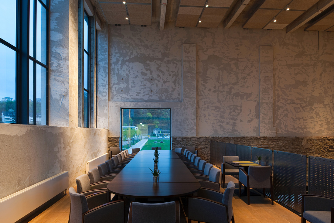Halle 32 restaurant in Gummersbach, featuring ERCO Optec spotlights highlighting industrial architecture.