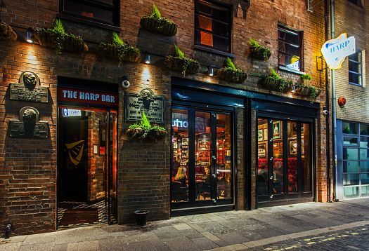 The Harp Bar in Belfast, a brightly lit pub with a traditional Irish atmosphere in the Cathedral Quarter.