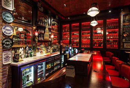 The Harp Bar in Belfast, a lively pub featuring LED lighting that recreates a traditional Irish atmosphere.
