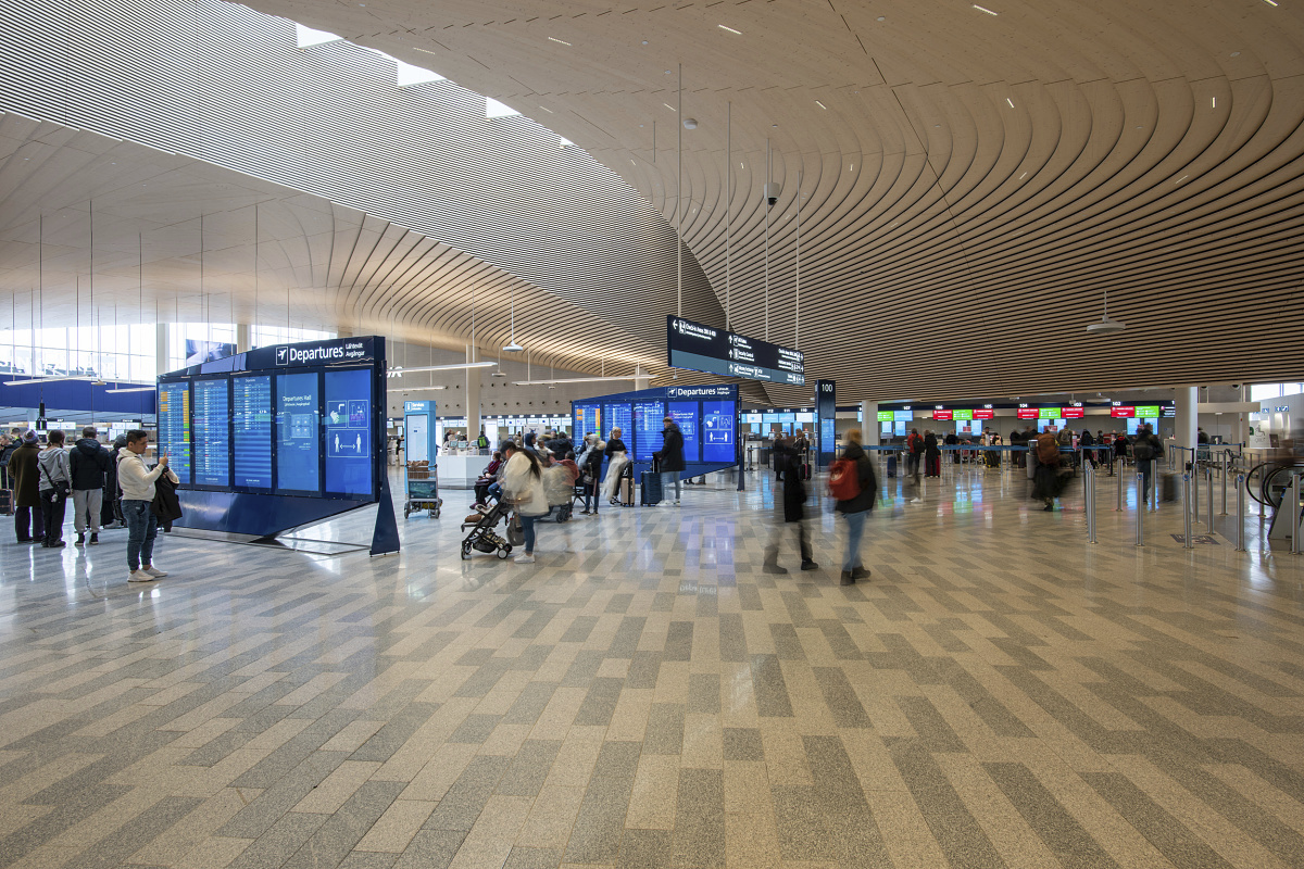 Bright LED lighting at Helsinki Airport, ceiling-integrated for high lumen output.