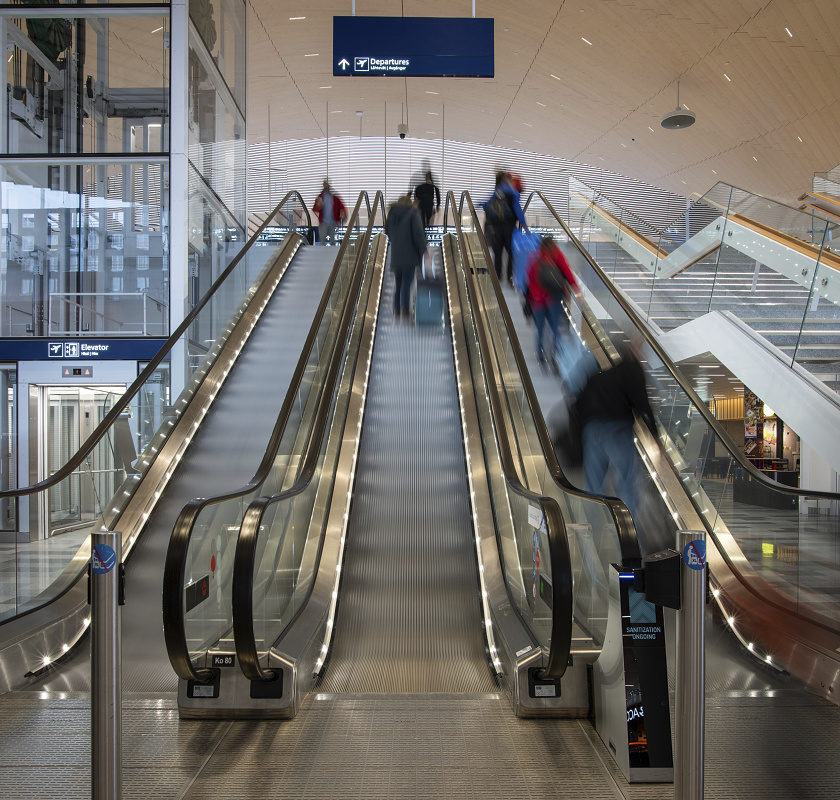 Helsinki Airport escalators with high lumen LED lighting for passengers.