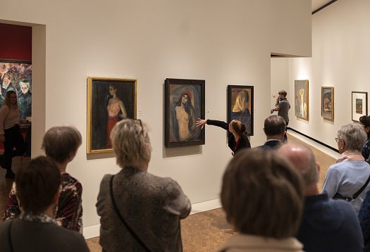 Visitors viewing Munch paintings in the Munch Museum, lit by ERCO spotlights for optimal color rendering.