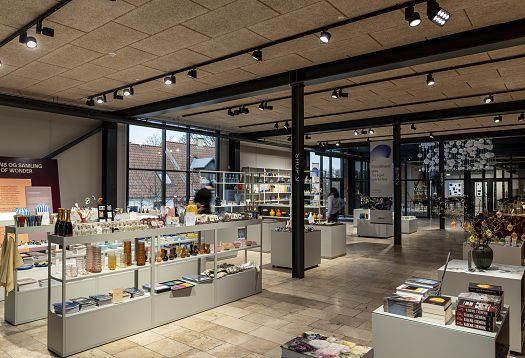 Holmegaard Værk museum shop featuring ERCO LED lighting for glassware and art objects.