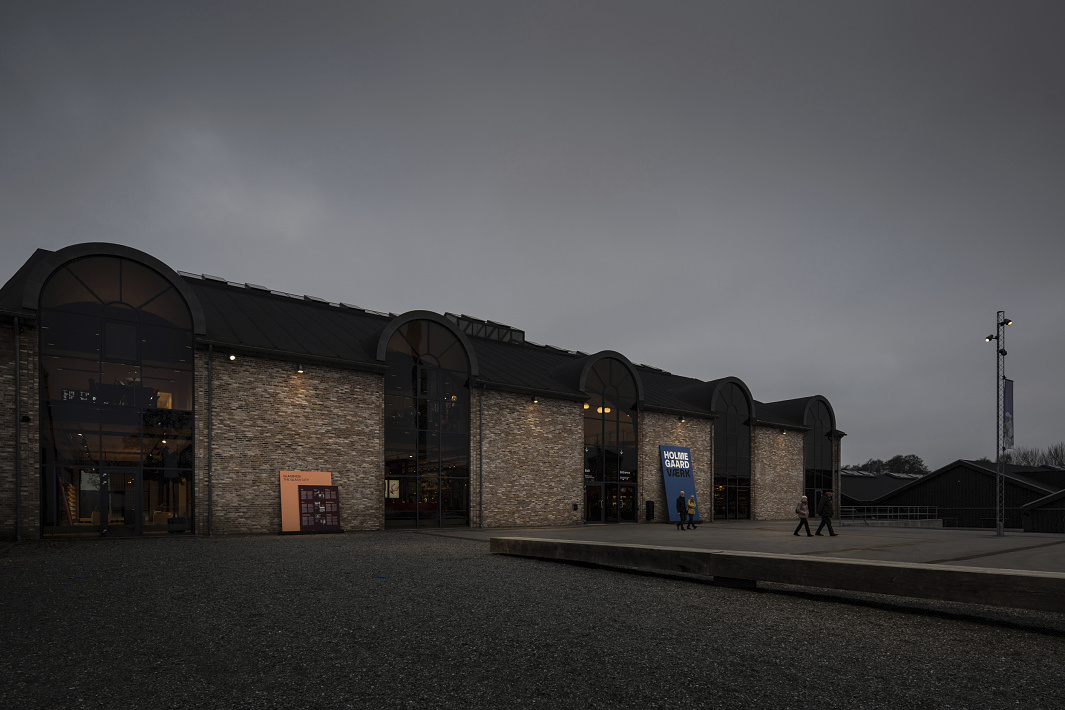 Holmegaard Værk glass museum in Denmark, showcasing glass art in historic architecture with ERCO LED lighting.