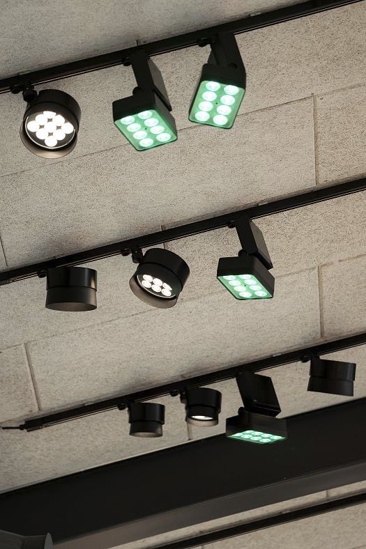 ERCO LED spotlights on tracks at Holmegaard Værk museum, Denmark, accenting glass art exhibits.