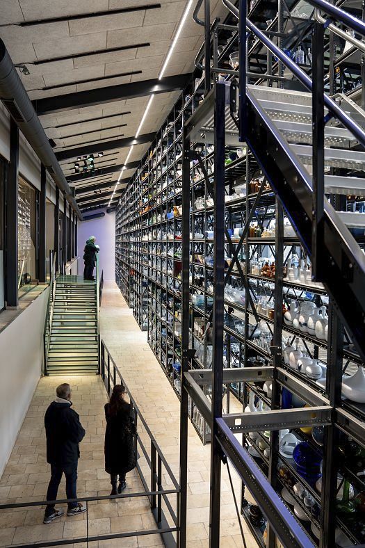 Holmegaard Værk glass museum: Glass objects on shelves, illuminated by ERCO LED spotlights.