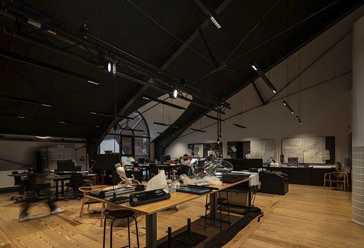 ERCO LED lighting in Holmegaard Værk museum, Denmark, showcasing glass art and historic architecture.