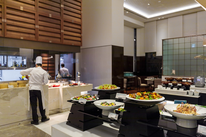 Salad and hot food buffet at Le Méridien Seoul, illuminated by ERCO spotlights for an inviting atmosphere.
