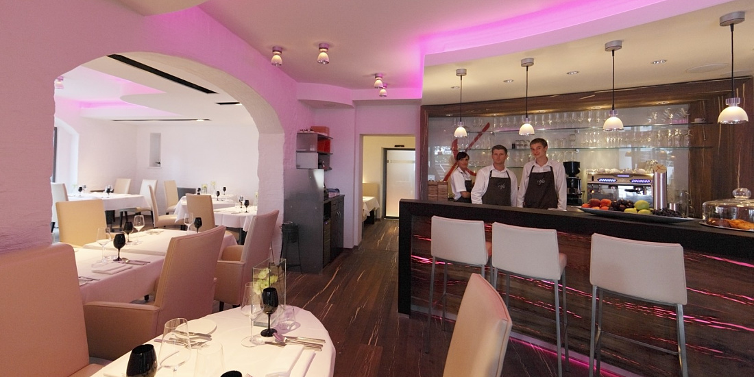 Interior of Hotel Nixe restaurant featuring ERCO lighting and staff behind the bar.