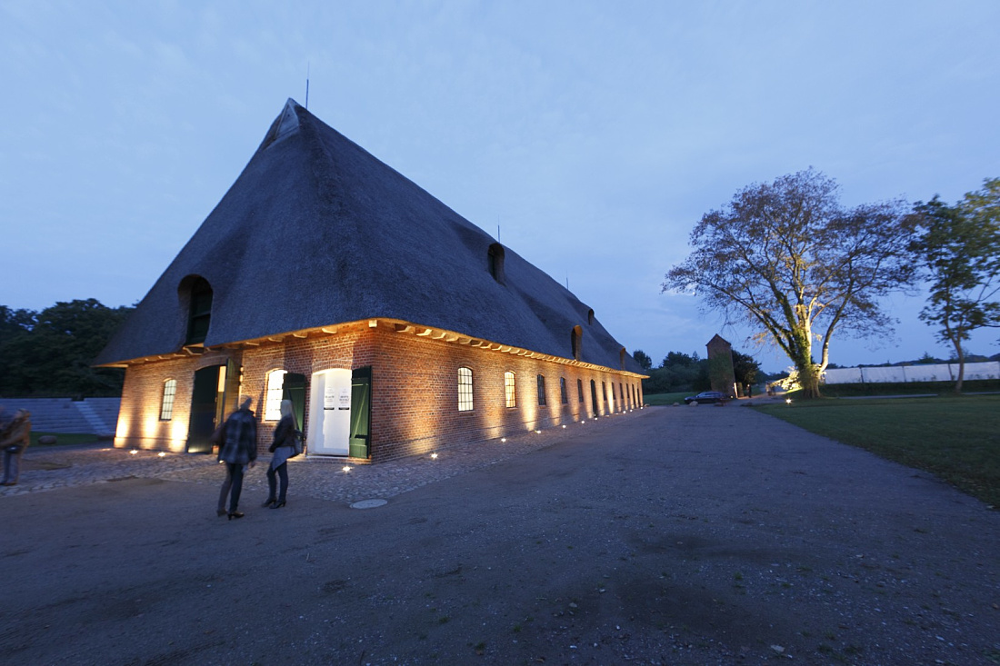 Illuminated building at Weissenhaus Grand Village Resort & Spa, featuring ERCO Optec spotlights.