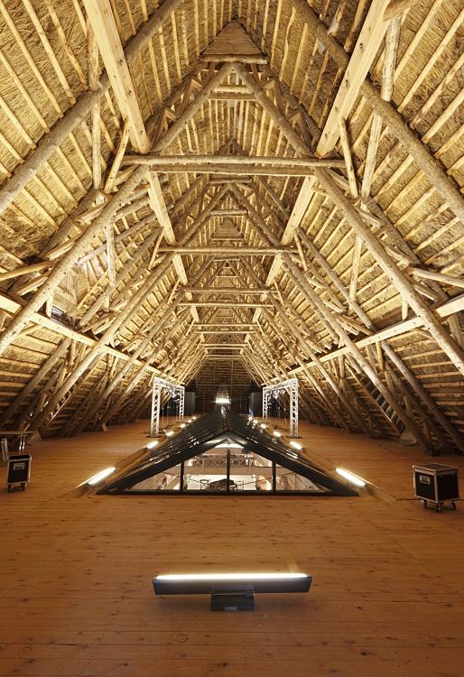 Wooden roof structure with ERCO lighting at Weissenhaus Grand Village Resort & Spa.