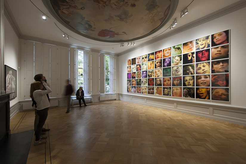 ERCO LED lighting at Huis Marseille Museum, Amsterdam, illuminating portrait photography on display.