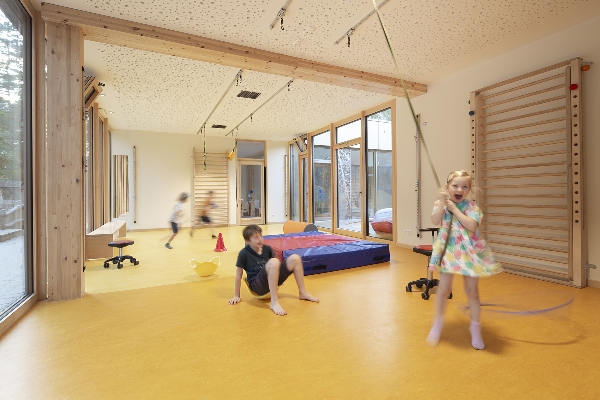 Children play in Rappelkiste Day Care Center, Berlin, with ERCO LED lighting for visual comfort.