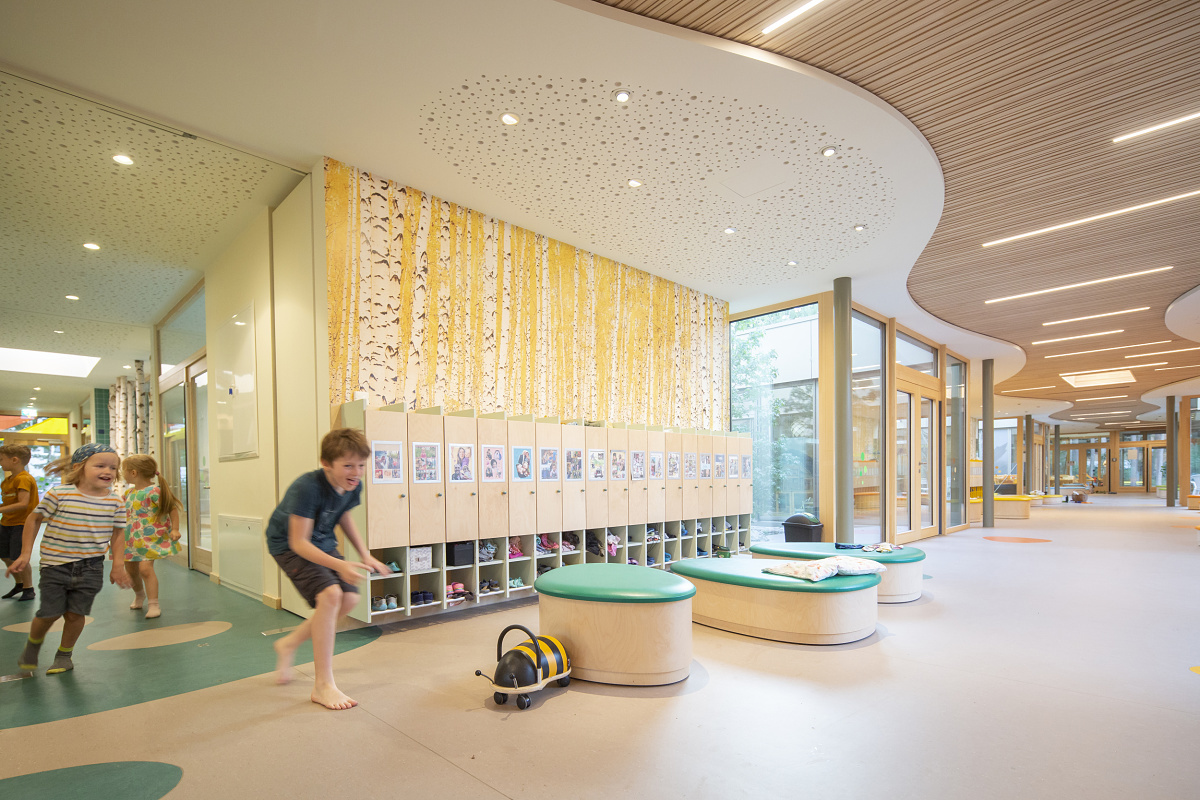 Children playing in Rappelkiste Day Care Center, illuminated by ERCO LED lighting for visual comfort.