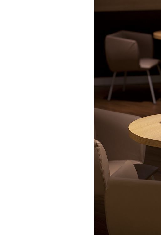 Yellow flower table decor in Ibis Hotel Bonn, lit by ERCO LED lighting.
