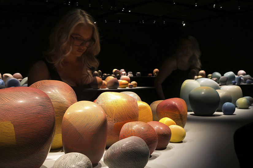 Visitors view Pippin Drysdale ceramics at John Curtin Gallery, illuminated by ERCO LED spotlights.