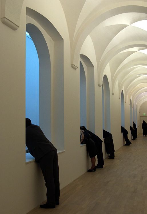 Visitors view art through windows at K21 Ständehaus, Düsseldorf, illuminated by ERCO lighting.