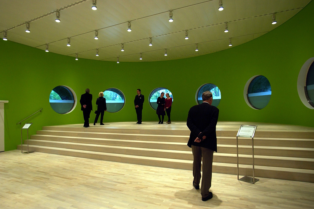 Visitors in K21 Art Gallery under ERCO Eclipse spotlights illuminating artworks.