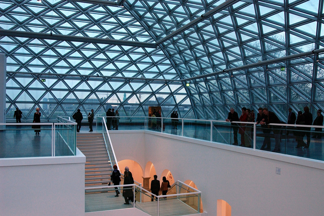 Interior of K21 Art Gallery featuring a glass dome and visitors, illuminated by ERCO lighting.