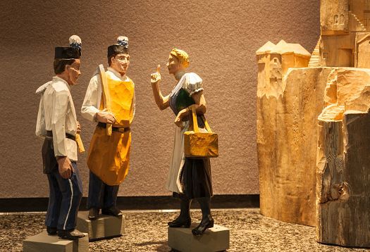 Wood-carved figures in Johann Grill Restaurant, Kempinski Hotel Berchtesgaden, illuminated by ERCO LED lighting.