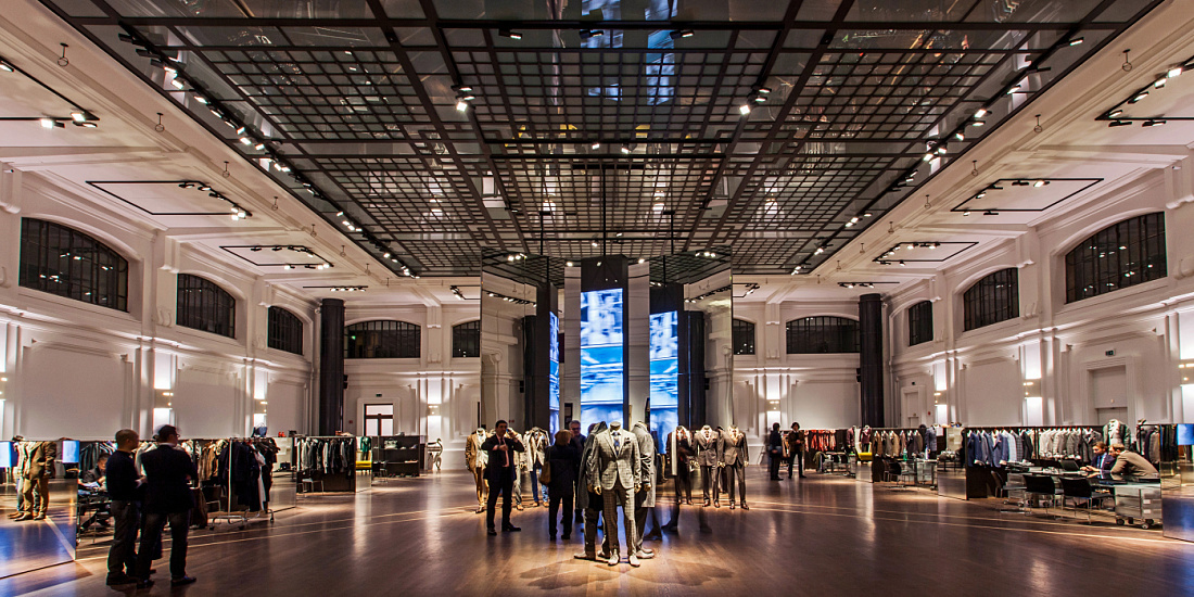 Kiton store in Milan, featuring ERCO LED lighting highlighting high-end menswear in a historic space.