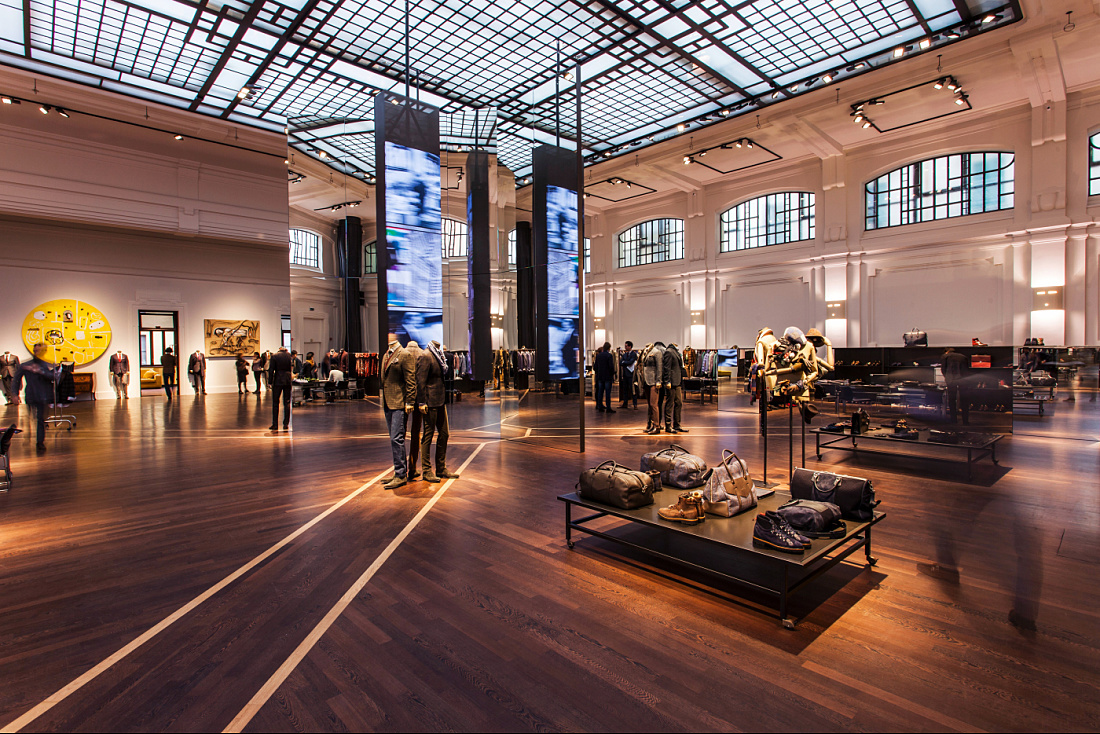 Kiton store in Milan, showcasing high-end menswear with ERCO LED lighting, accentuating details.