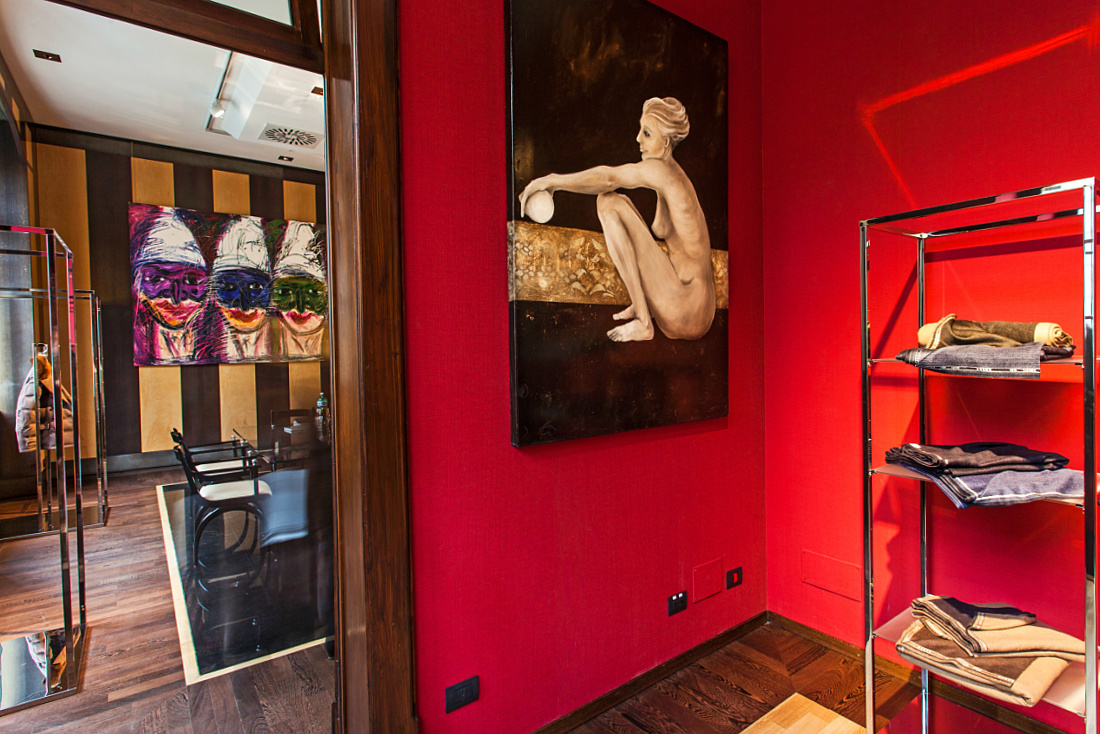Kiton store in Milan featuring art and fashion, highlighted by LED accent lighting.