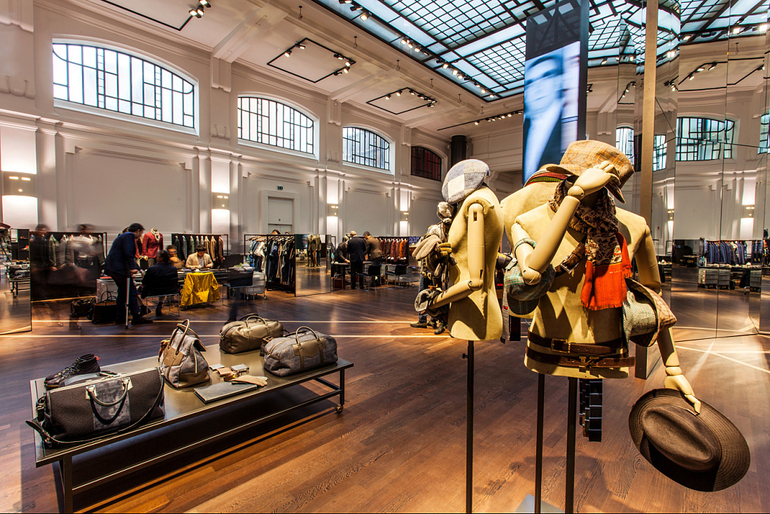 Kiton store in Milan showcasing menswear with ERCO LED lighting, highlighting the tailoring and materials.