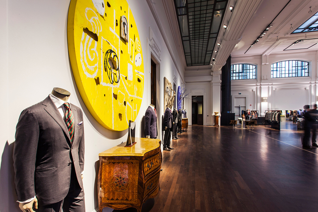 Kiton store in Milan, showcasing menswear with LED lighting and architectural accents.
