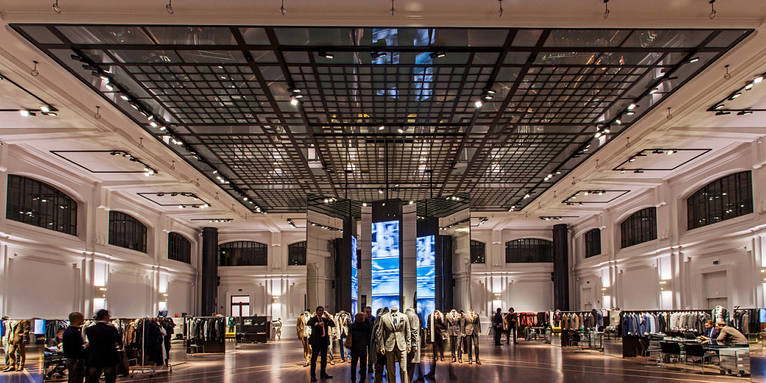 Kiton store in Milan, featuring ERCO LED lighting highlighting high-end menswear in a historic space.