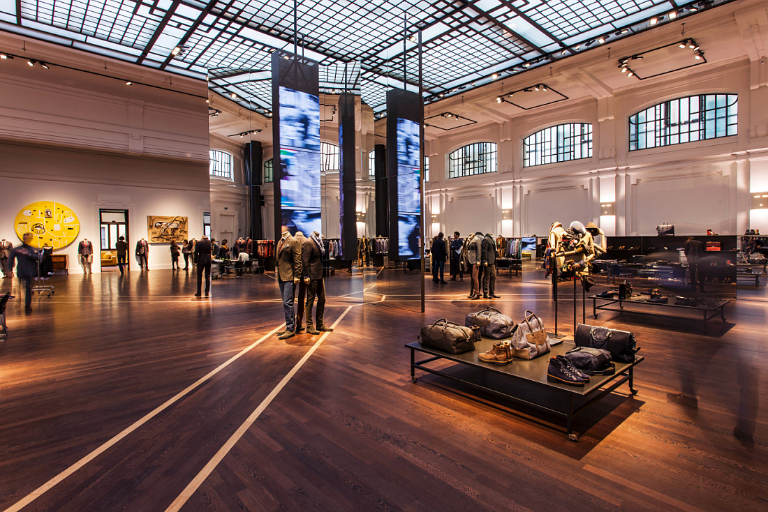 Kiton store in Milan, showcasing high-end menswear with ERCO LED lighting, accentuating details.