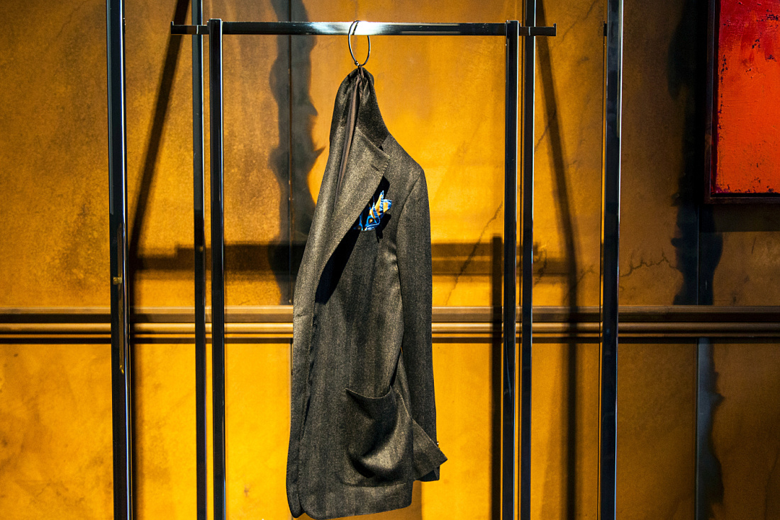 Kiton suit in Milan store, illuminated by ERCO LED lighting for accentuating details.