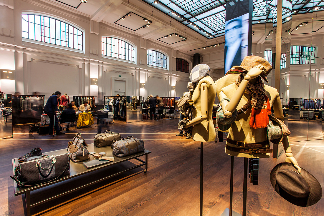 Kiton store in Milan showcasing menswear with ERCO LED lighting, highlighting the tailoring and materials.