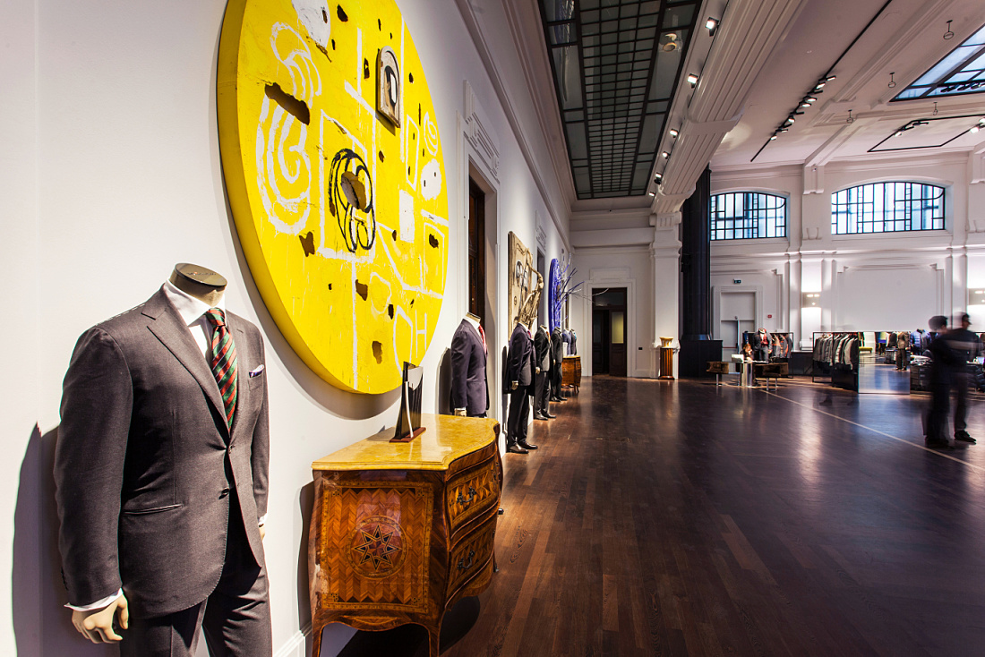 Kiton store in Milan, showcasing menswear with LED lighting and architectural accents.