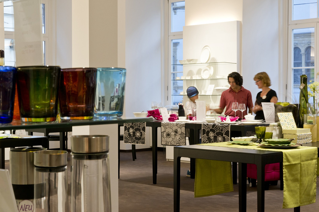 Klammerth tableware store in Graz with LED-lit dishware and customers.