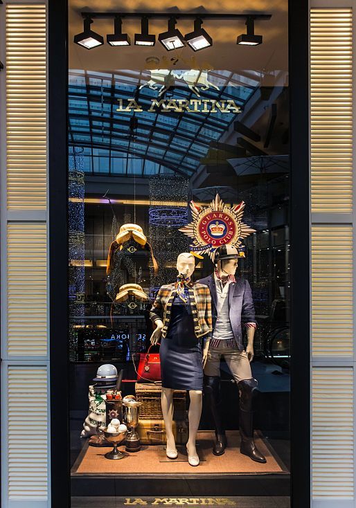 La Martina boutique in Prague, illuminated by ERCO LEDs, showcasing polo fashion in a bright, friendly ambiance.