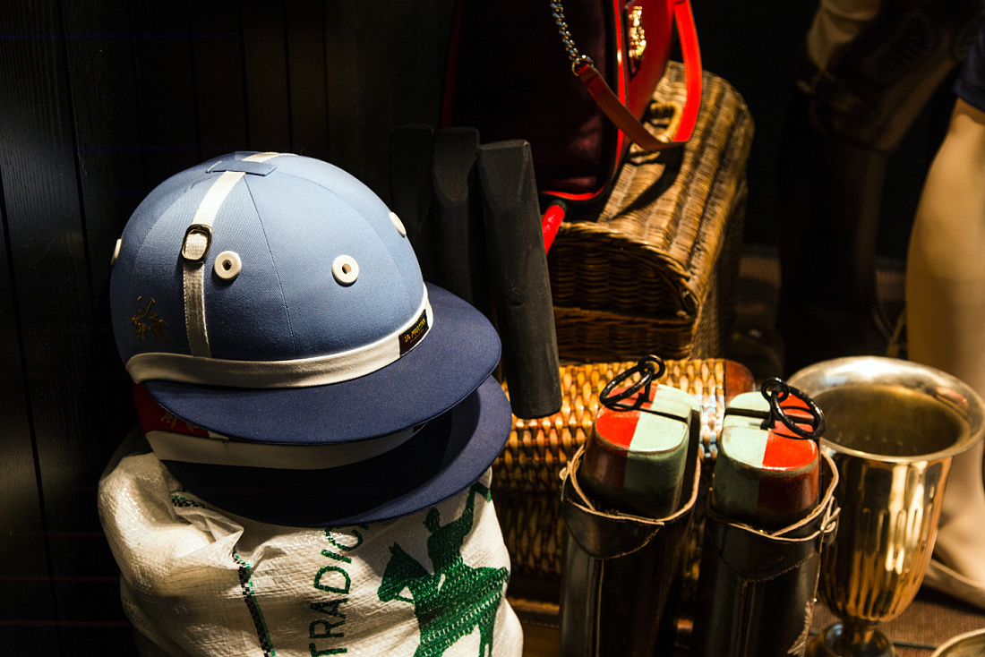 La Martina polo helmet in Prague boutique display, lit by ERCO LED spotlights.