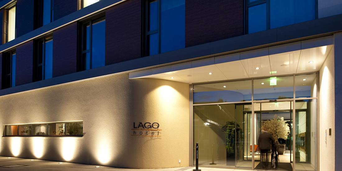 Illuminated entrance of the LAGO Hotel in Ulm, showcasing its inviting design.