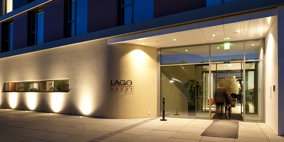 Illuminated entrance of the LAGO Hotel in Ulm, showcasing its inviting design.