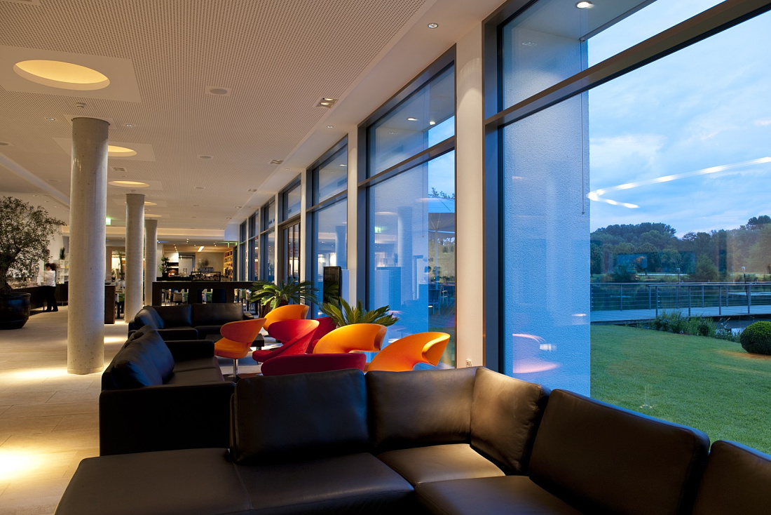 LAGO Hotel lobby in Ulm featuring ERCO lighting, creating a relaxing atmosphere for modern hospitality.