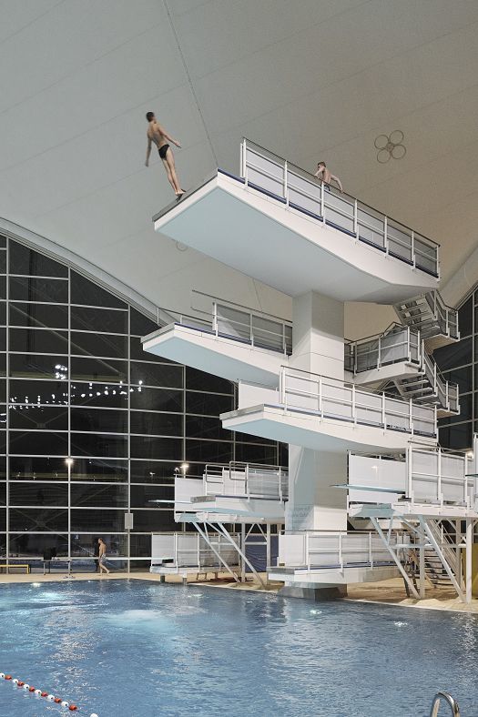 Diver on a diving platform at the Aquatic Center, Olympic Park Munich, with ERCO LED lighting.