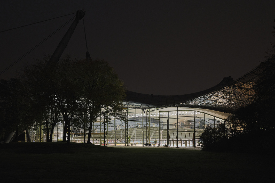 Aquatic Center at Olympic Park, Munich, illuminated at night with ERCO LED lighting.