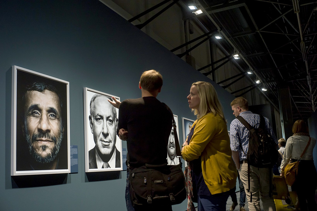Visitors view portraits at the Leica gallery, illuminated by ERCO LED spotlights at Photokina 2012.
