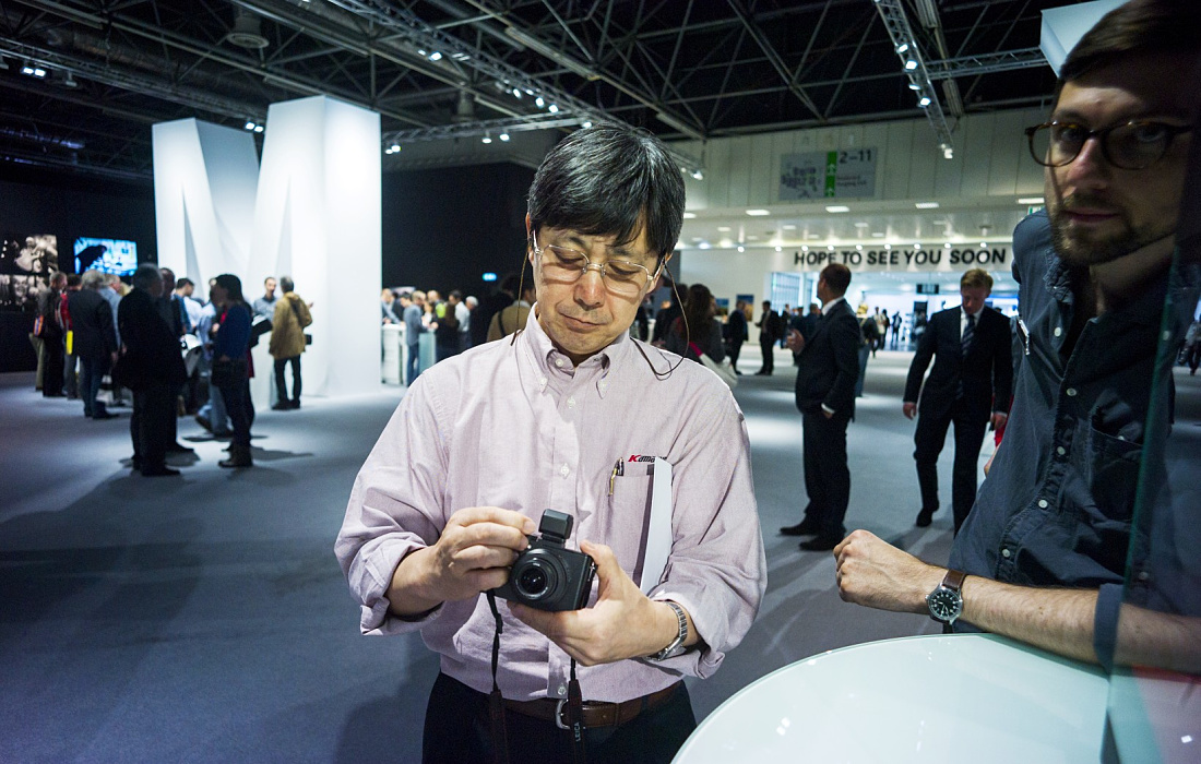 Visitor with Leica camera at Photokina 2012, illuminated by ERCO LED spotlights.
