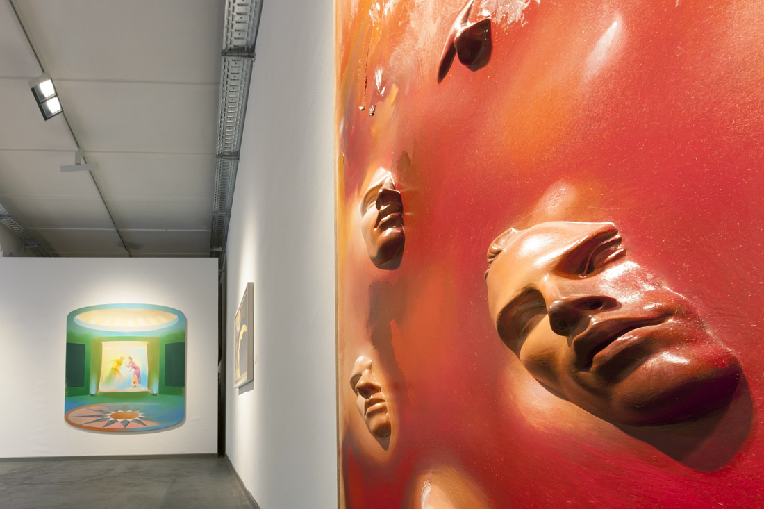 Levy Gallery art installation featuring face sculptures, illuminated by ERCO lighting.