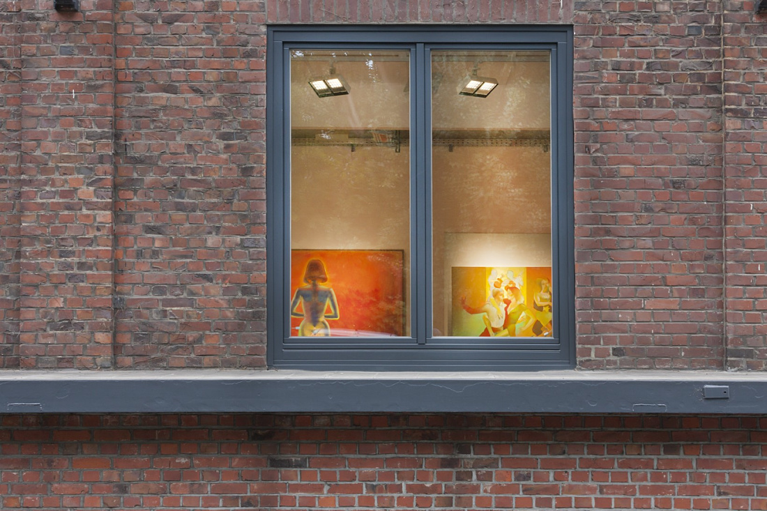 Levy Gallery window view featuring artworks illuminated by ERCO lighting.