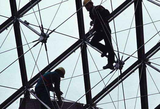 Workers inspect the Louvre Pyramids steel structure for ERCO lighting.