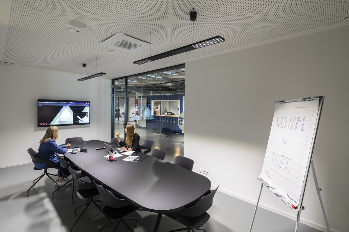 ERCO LED track lighting in a flexible co-working space for adaptable illumination.