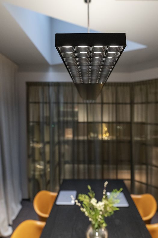 ERCO Jilly downlight providing flexible office lighting in a co-working space.